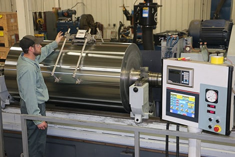 a man inspecting rolled services